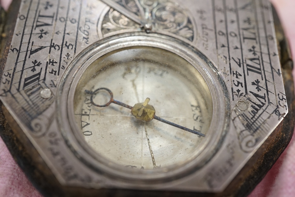 An early 18th century French silvered Butterfield pattern pocket sundial by Bion, Paris, with engraved octagonal plate and the gnomen supported by birds, the reverse engraved with the latitudes of various European cities